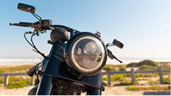Motorcycle accessories (helmet, gear), representing Accessories Damage coverage.